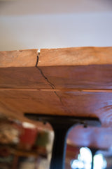 Close-up view of a natural crack along the thick edge of the redwood tabletop.