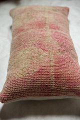 Distressed Oushak lumbar pillow, soft rose and natural beige textured pile.