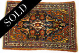 Lower border detail of the vintage Bijar rug, showing tribal motifs and hand-spun wool fringe.