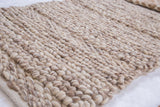 Chunky hand-woven pure wool texture of Birdie rug in variegated beige and cream.