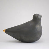 Black porcelain turtle dove with smooth glazed finish and elegant gold tip.