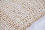 Blanched Jute rug with natural hand-braided texture and woven edge detail.