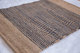 Coby jute rug's close-up of braided texture and dark grey geometric pattern.