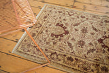 Corner detail of an Egyptian rug runner's European-influenced Sultanabad design in wine red and brown tones.