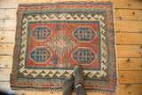 Antique Caucasian Kazak rug detail: madder red field, sky blue octagonal motifs, reciprocating border.