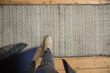 Distressed Tulu rug runner, showcasing ivory, slate blue chevron pattern and even foundation wear.