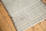 Distressed Tulu runner with wavy chevron pattern, foundation showing in ivory, silver, slate blue.