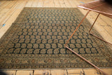 Corner of a Tabriz antique rug with an unusual charcoal field and intricate germinating boteh pattern.