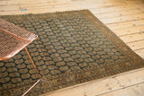 Antique Tabriz rug corner: intricate germinating botehs on charcoal field, ivory border, mostly even wear.