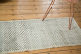 Distressed character and diminutive checker motif of the vintage Oushak runner.