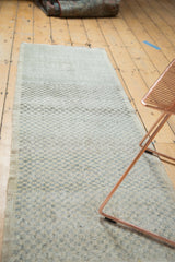 Distressed checker motif on a vintage Oushak runner with dye lot shift.