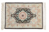 Finely woven vintage Hereke silk rug with dark navy roundel medallion and intricate floral field.
