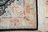 Finely woven ivory field with intricate pastel floral blossoms, navy border, and fringe.
