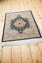 Intricate floral patterns, dark navy border, and fringe on a vintage Turkish Hereke rug corner.