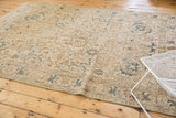 Distressed vintage Tabriz carpet with an allover geometric motif in muted tones.