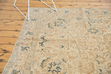 Distressed vintage Tabriz carpet border, ivory field, brown and dark navy teal motifs.
