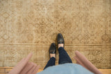 Vintage distressed Amritsar rug, low pile surface showing lattice Herati motifs in gold and sand.