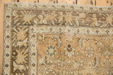 Intricate floral and plant motif borders showing the distressed texture of a vintage Malayer carpet.