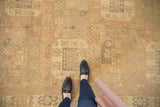 Soft, low pile of distressed Oushak rug, featuring dusty sand, slate gray gul motifs.