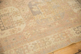 Distressed vintage Oushak rug showing low pile, geometric and floral motifs in soft blush, ivory, slate tones.