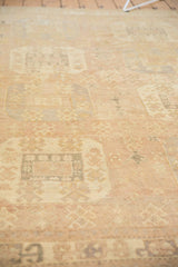 Distressed low pile texture of an Oushak, showing muted sand, ivory, and gray stylized guls.