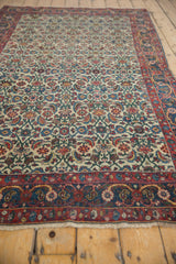 Vintage Halvai Bijar rug with intricate ivory Herati field, framed by rich blue and brick red borders.