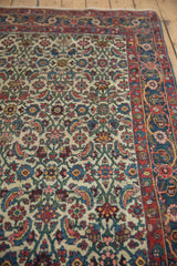 Intricate Herati motif with sky blue, madder red on ivory ground, meeting a patterned border.