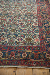 Halvai Bijar rug's intricate weave, Herati motif on ivory ground, with red and blue border.