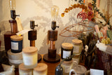Artisan Edison lamps with copper coils styled with curated home decor items.