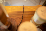 The Edison lamp's vintage-style twisted cloth cord and solid dark-grained oak base.