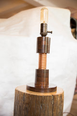 Small Edison lamp featuring a solid oak base, hand-twisted copper coil, and vintage filament bulb.