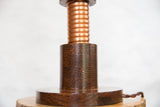 Richly grained solid oak wood base with hand-twisted copper coil details.