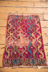 End border of an antique Turkish Yastik rug with germinating plants and tattered fringe.