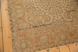 Corner of a Vintage Sivas rug with arabesque main border, meandering leaf minor borders, and muted colors.