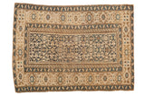 Antique Caucasian rug, circa 1910s, with navy and sand geometric serpent motifs.