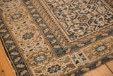 Geometric border and field with serpent motifs in blue, sand, and beige tones.