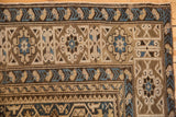 Upper corner of antique Caucasian rug, with intricate geometric borders in sky blue, sand, and bronze.
