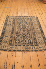 Antique Caucasian rug's corner with geometric navy, sand, sky blue border and fringe.