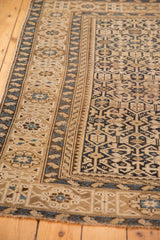 Antique hand-knotted Caucasian rug: geometric field, abstract serpents, sand and navy blue borders.