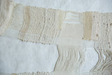 Lea Thomas Magnolia weaving detail: mixed textures, soft cream tones, and hand-woven fringed elements.