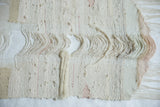 Lea Thomas Magnolia Weaving detail featuring thick ribbed wool and pale pink accent threads.