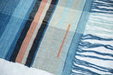 Handmade Lea Thomas weaving featuring blue, light gray, and peach striped hand-dyed yarns.