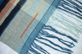 Soft hand-dyed blue and aqua fringes of the Lea Thomas weaving.