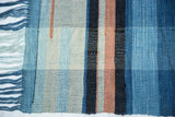 Woven texture of Lea Thomas textile, featuring natural hand-dyed blue, peach, and cream stripes.