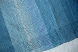 Textured hand-dyed blue and ivory stripes on Lea Thomas's artisanal weaving.