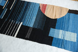 Textured section of Channels weaving, featuring bold black, blue, and white geometric patterns.