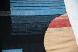 Lea Thomas Channels Weaving detail: textured blue, black, red, and beige woven patterns.