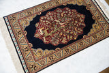 Fine Hereke rug showing the lustrous pile and pictorial Tree of Life design from an angle.