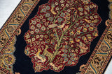 Finely detailed Tree of Life on a vintage Hereke rug with perched birds and deer on a cherry red field.