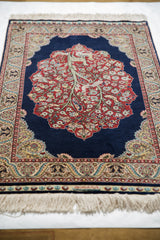 Angled perspective of the fine Hereke rug highlighting its intricate tree of life design.